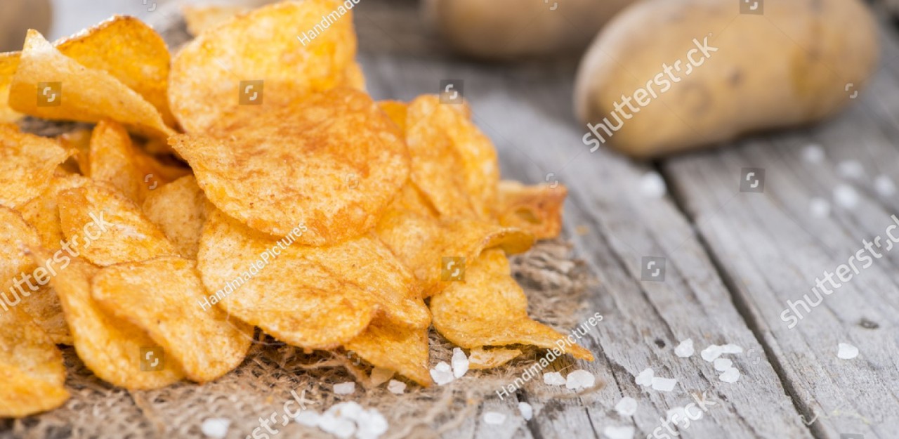 stock-photo-heap-of-paprika-potato-chips-on-rustic-background-156787919